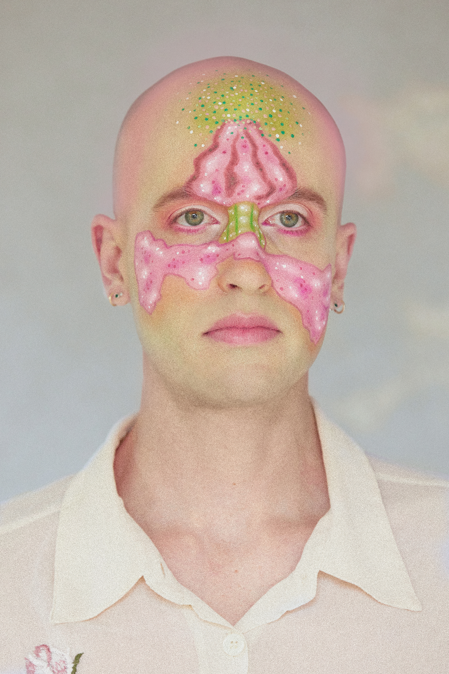 Chest-up portrait of Jesse Clark with artistic facepaint of a colorful fire poppy flower